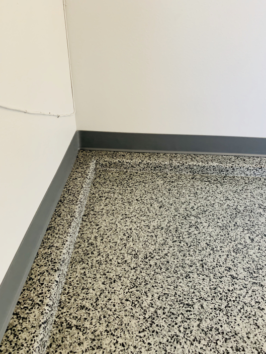 Flake epoxy floor with cove base
