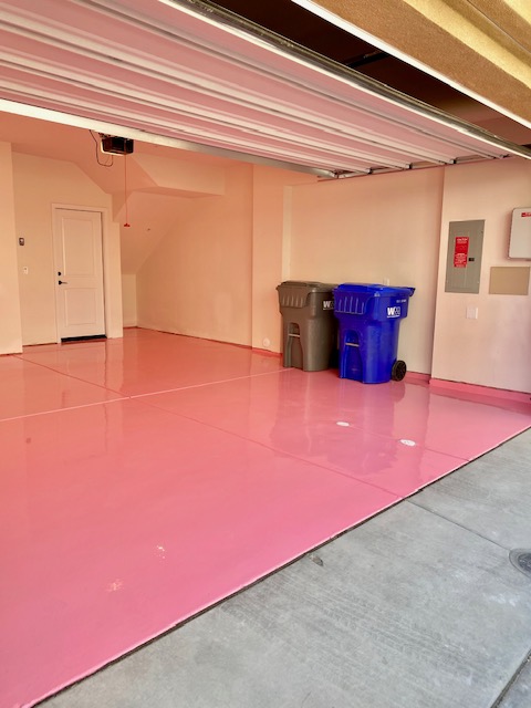 Pink solid-color epoxy floor in a utility room