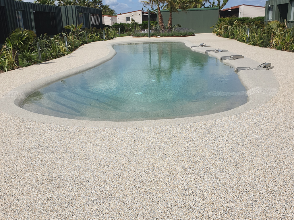 Pool deck coating around a backyard pool