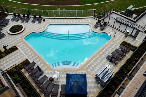 Pool deck coating around a backyard pool