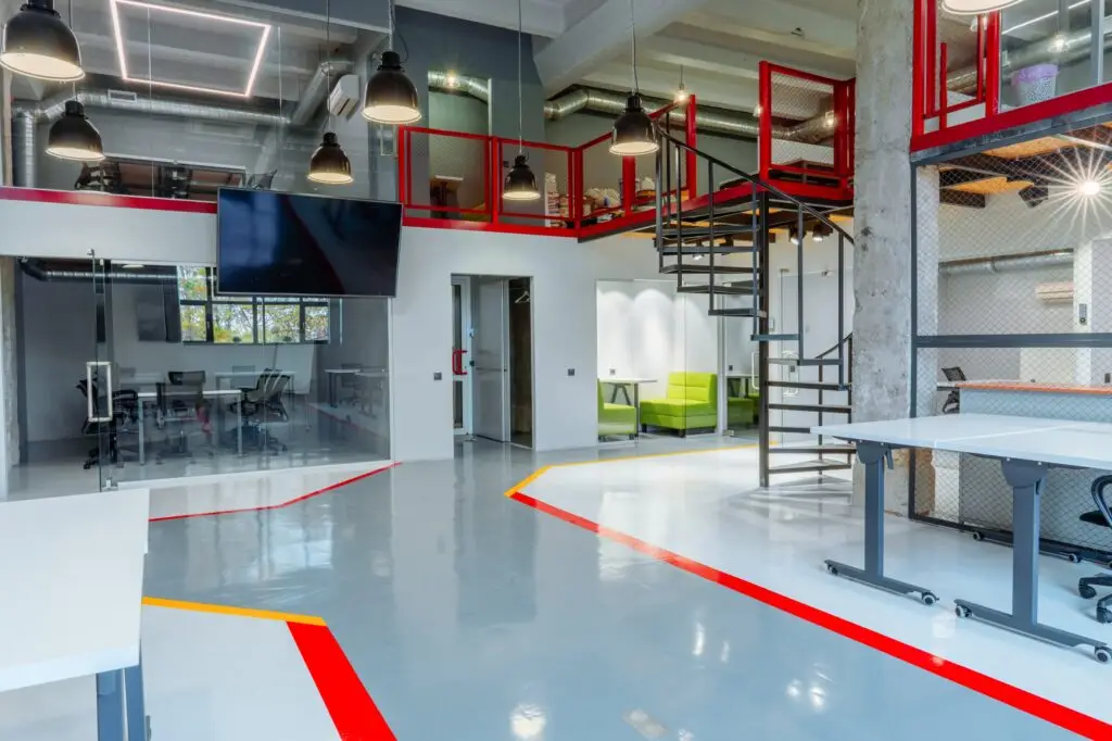 Commercial space with a gray coated floor and red safety lines